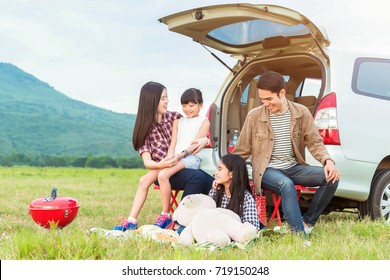 Drive In The Vacations Family; Asian Family Are Happy Sitting In The Open Trunk Of A Car;  Travel Nature Trip.