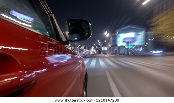 Drivelapse urban\
look from fast driving car at a night avenue in a city timelapse\
hyperlapse, road with lights reflected on car at high speed. Rapid\
rhythm of a modern\
city.