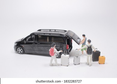 Driver Of A Airport Shuttle Minivan, Greeting His Passengers With Their Luggage