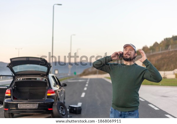 Driver\
with a big problem with the car on the\
highway