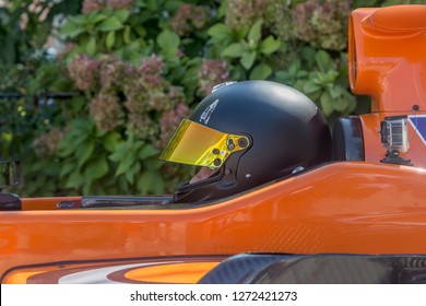 Driver In Black Helmet Sitting In Racecar