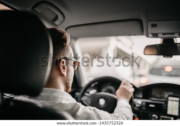 driver businessman rides a business\
class car in the city in sunglasses. luxury taxi\
services.