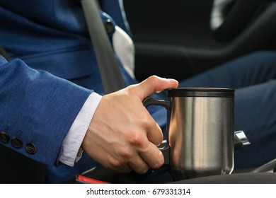 The Driver In The Car Takes A Thermos Mug With A Coffee Bar So As Not To Fall Asleep At The Wheel