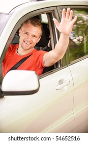 Driver Of Car Waves Hand As A Sign Of Greeting.