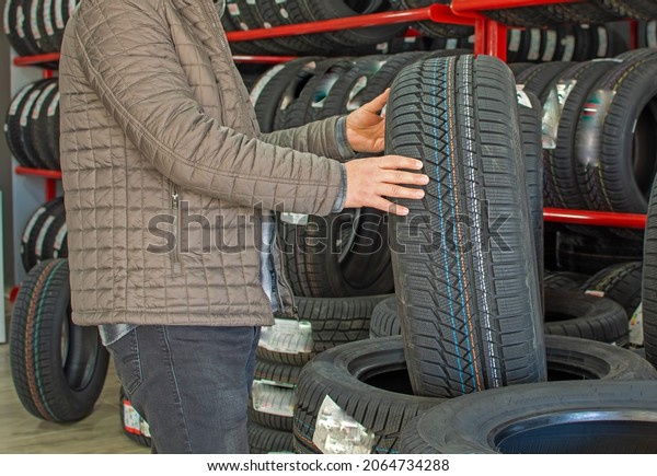 A driver
choosing tires for his car at the
store.