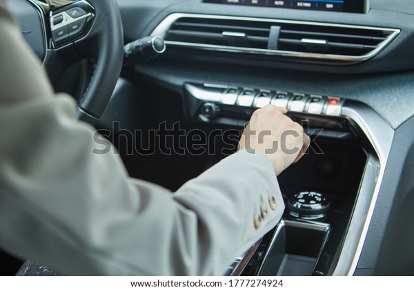 the driver controls the air conditioning in a modern\
electric car