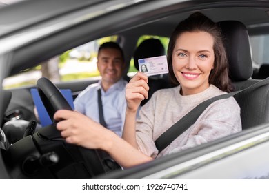 driver courses, exam and people concept - young woman with license and driving school instructor with clipboard in car - Shutterstock ID 1926740741