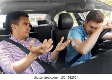 Driver Courses And People Concept - Driving School Instructor Talking To Sad Man Failed Exam In Car