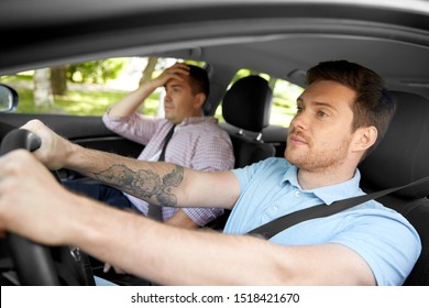 Driver Courses And People Concept - Driving School Instructor Talking To Sad Man Failed Exam In Car