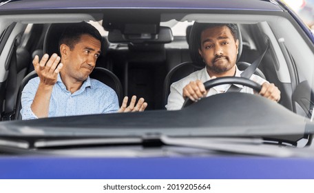 Driver Courses And People Concept - Driving School Instructor Talking To Sad Man Failed Exam In Car