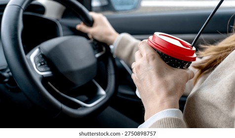 Driver drinks coffee while driving a car