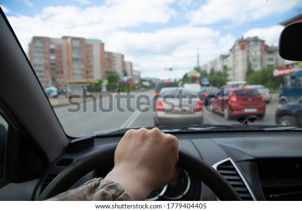 The
driver drives a car around the city in the
summer.