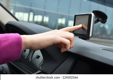 Driver entering an address into the navigation system