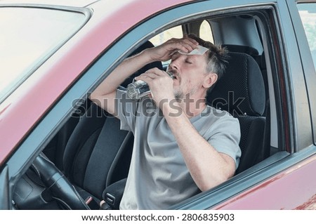Driver experiencing heatstroke, sweat and dehydration in hot car