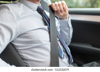 Driver Fastening His Seat Belt Before Starting Car