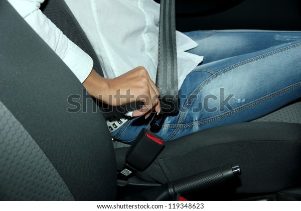 driver fastening seat belt in\
car