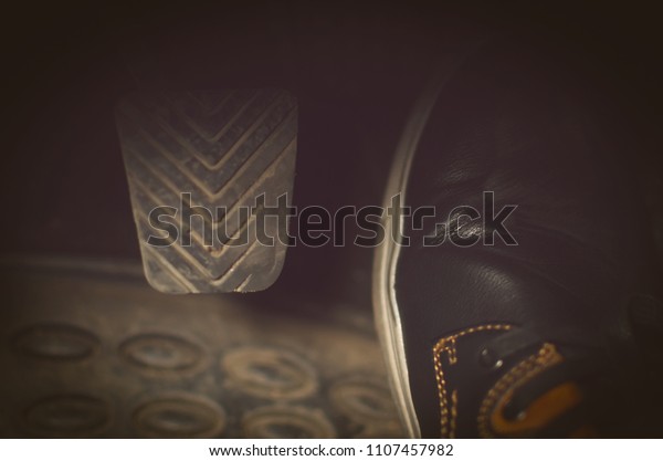 Driver foot on gas pedal of car close up photo.\
Car travel concept.
