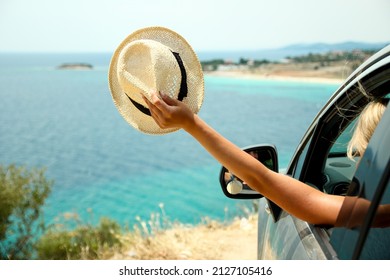 driver girl in car at sea in summer - Shutterstock ID 2127105416