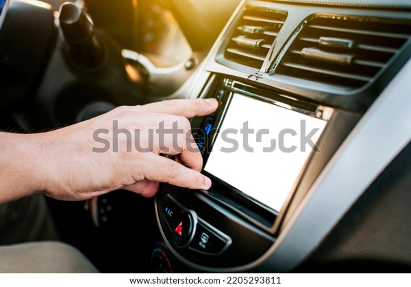Driver hands changing the radio\
station. Close up of hands changing the car radio station. Concept\
of driver tuning the radio. Driver man changing radio\
station