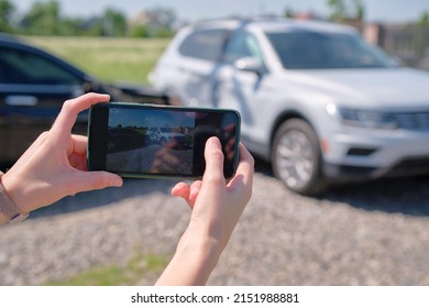 Driver Hands Taking Photo On Mobile Phone Camera After Vehicle Collision On Street Side For Emergency Service After Car Accident. Road Safety And Insurance Concept