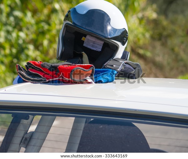 driver helmet and\
gloves on a car rooftop