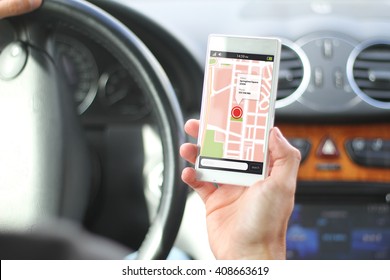 driver holding smartphone with gps map app interface. All screen graphics are made up. - Powered by Shutterstock