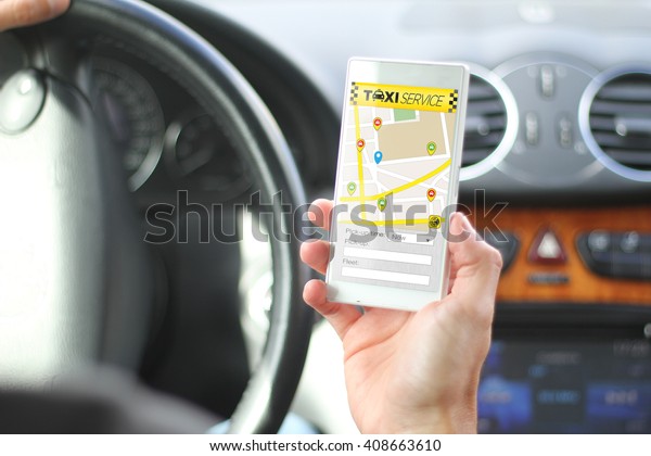 driver holding smartphone with taxi app\
interface. All screen graphics are made\
up.