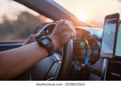 A driver interacts with a smartwatch and smartphone showing navigation and eco car technology while driving at sunset. - Powered by Shutterstock