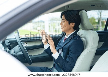 Driver letting go of the steering wheel while driving. Autonomous car. Hands free driving. Automatic driving. Automatic parking.