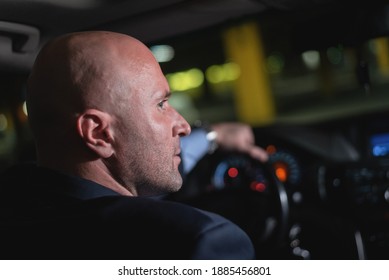 Driver is looking a car side window.