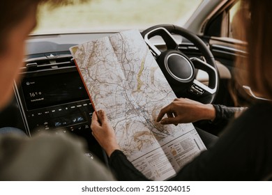 Driver looking at map in car photo - Powered by Shutterstock