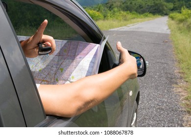 Driver looking on map in car