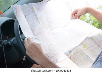 Driver looking on map in car