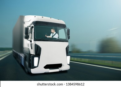 Driver Looks Into The Digital Tablet While The Self Driving Truck Is Driving On The Highway.