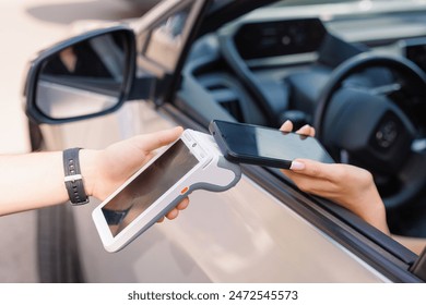 the driver makes contactless NFC payment using a mobile phone - Powered by Shutterstock