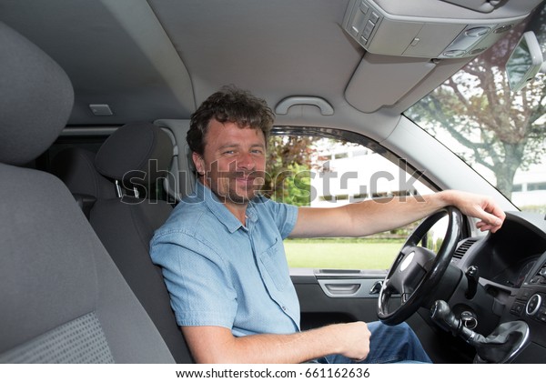 driver man in blue shirt in\
van