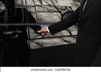 Driver Opening Door Of Luxury Car, Closeup. Chauffeur Service