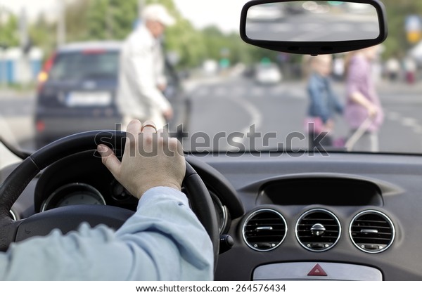 The driver and a\
pedestrian at a crosswalk