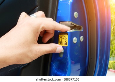 A Driver Is Pressing On Child Lock Button At Car's Door