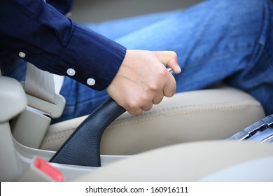 Driver Pulling The Hand Brake In Car