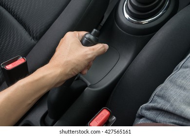 Driver Pulling The Hand Brake In Car