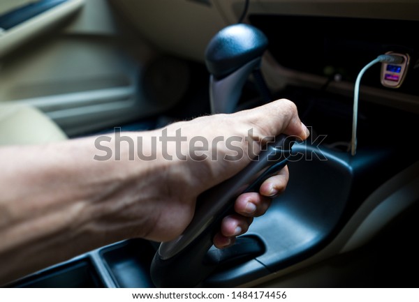Driver pulls\
the hand brake lever after car\
stop