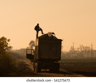 Driver Puts Tarp On Truck