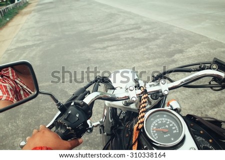 Similar – Senior man steering motorcycle on road