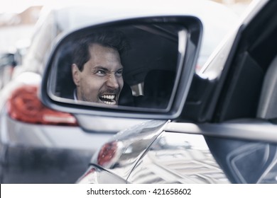 Driver With Road Rage Reflected In Wing Mirror