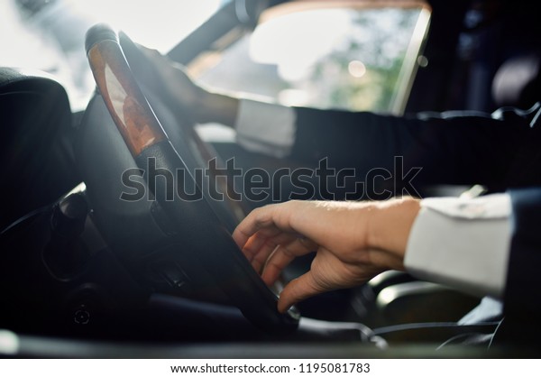 the\
driver sits behind the wheel of a car               \
