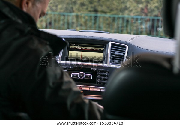 Driver sitting in a luxury\
car.