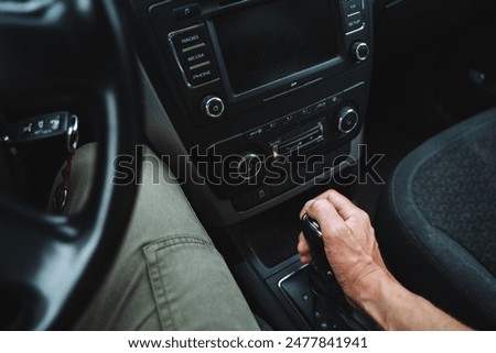 The driver skillfully utilizes the car, engaging with its design and smoothly navigating with one hand on the gear shift. Keywords Car, Vehicle, Automotive design, Motor vehicle, Steering
