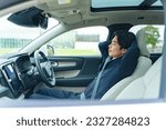Driver sleeping in a car. Autonomous car. Self-driving vehicle. Break. Sleeping in the car.