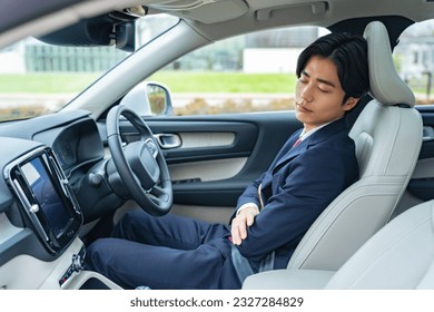 Driver sleeping in a car. Autonomous car. Self-driving vehicle. Break. Sleeping in the car. - Powered by Shutterstock